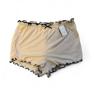cream & black ruffle trim shorts